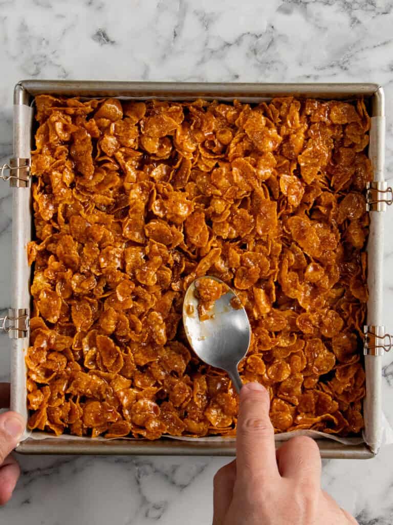 Spreading the cornflakes over the brownies