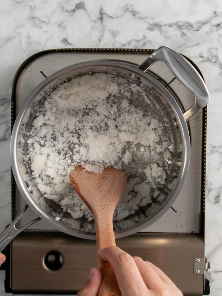 Stirring as the sugar clumps up