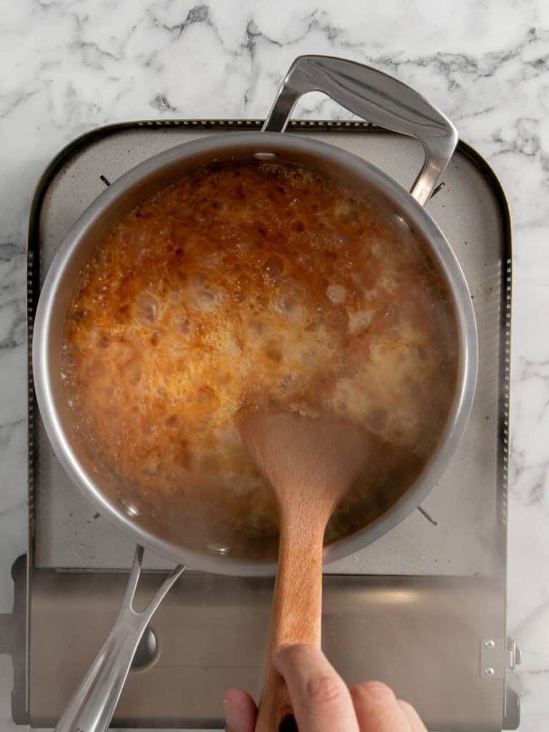 Adding the cream to the toffee to stop it cooking any further