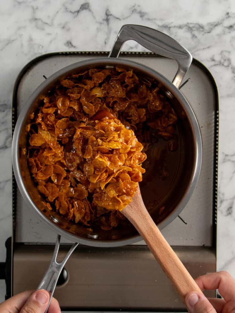 Folding the cornflakes through the toffee
