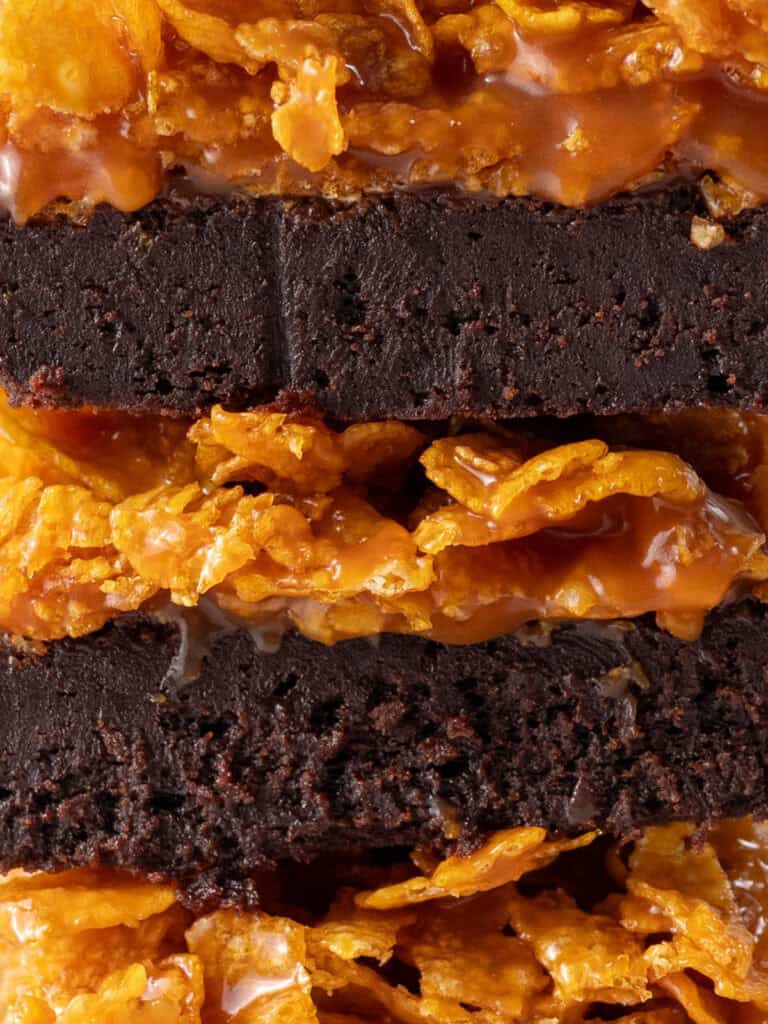 Extreme close up of a stack of crispy caramel topped brownie bars