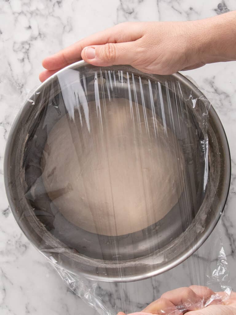 Covering the bowl tightly with plastic wrap