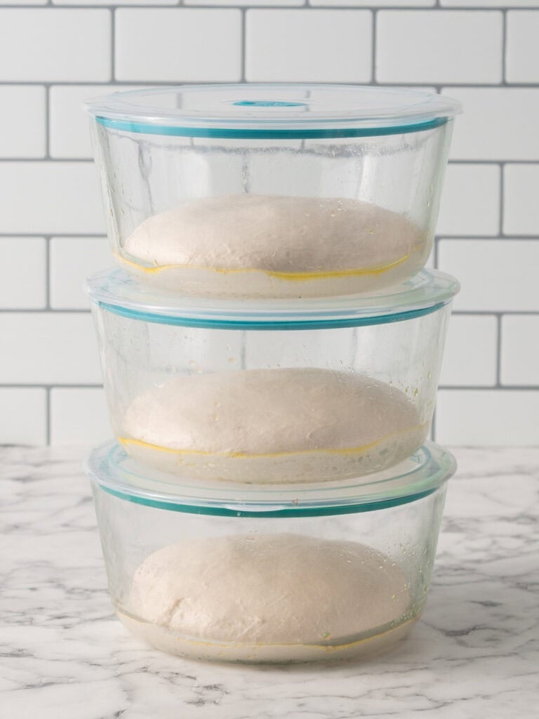 Placing the dough in glass containers to let it slow rise at room temp before baking