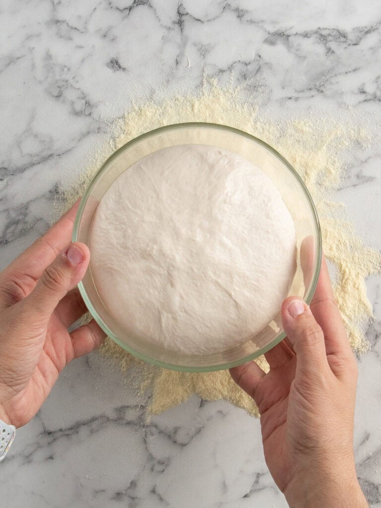 Showing how puffed the dough is in the container after it's had it's final room temp proof
