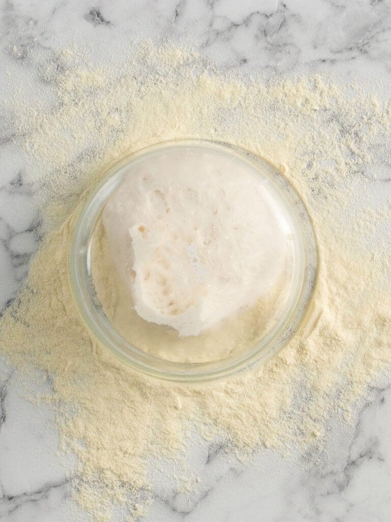 Turning the container upside down on top of the semolina to let it fall out naturally
