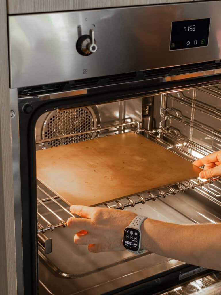 Adding pizza steel on top of an oven shelf