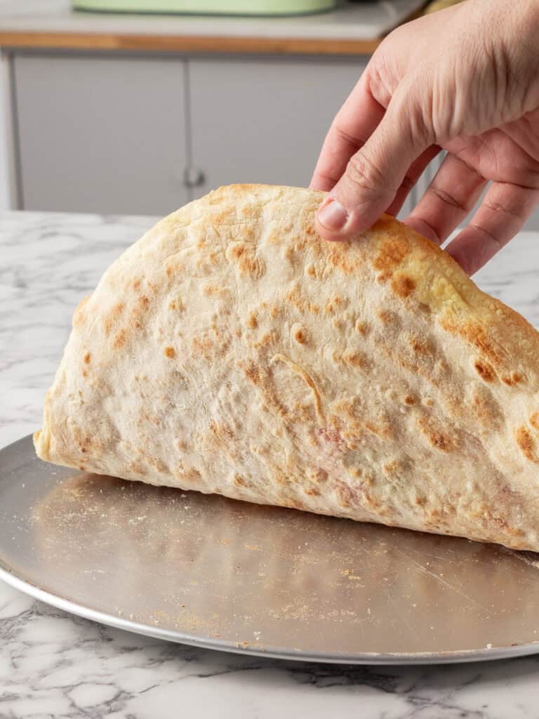 Showing how crispy the bottom of the oven baked pizza is