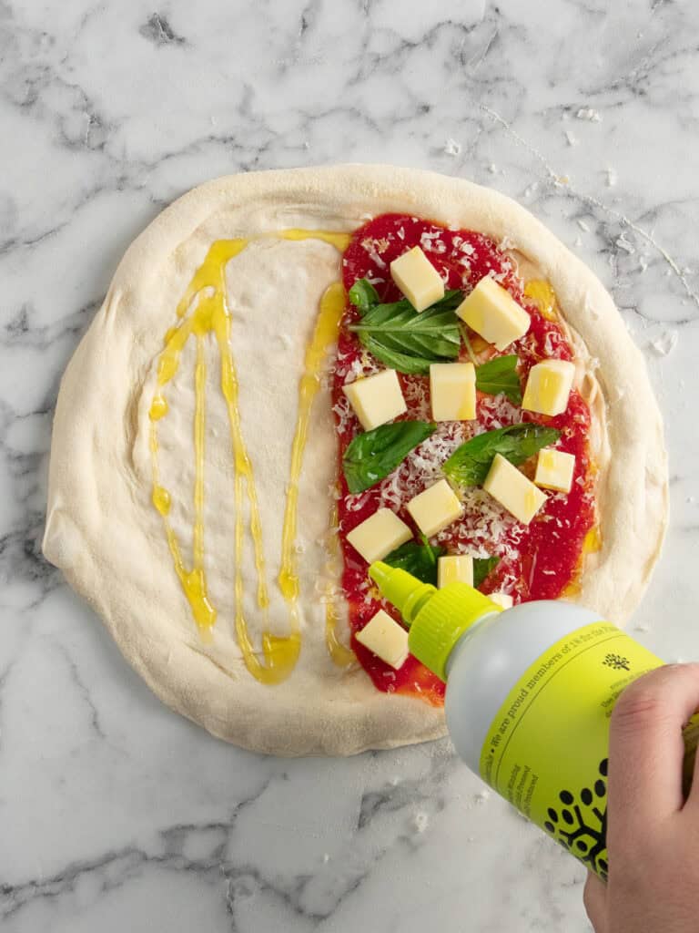 Drizzling a good dollop of olive oil all over the calzone pizza